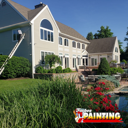 Crew prepping and spraying a two-story home exterior